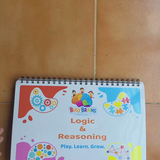 Toddler flipping through Busy Brains Logic and Reasoning Activity Binder with Montessori learning pages